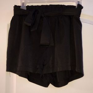 Adorable black mini shorts, with cute fringe & bow